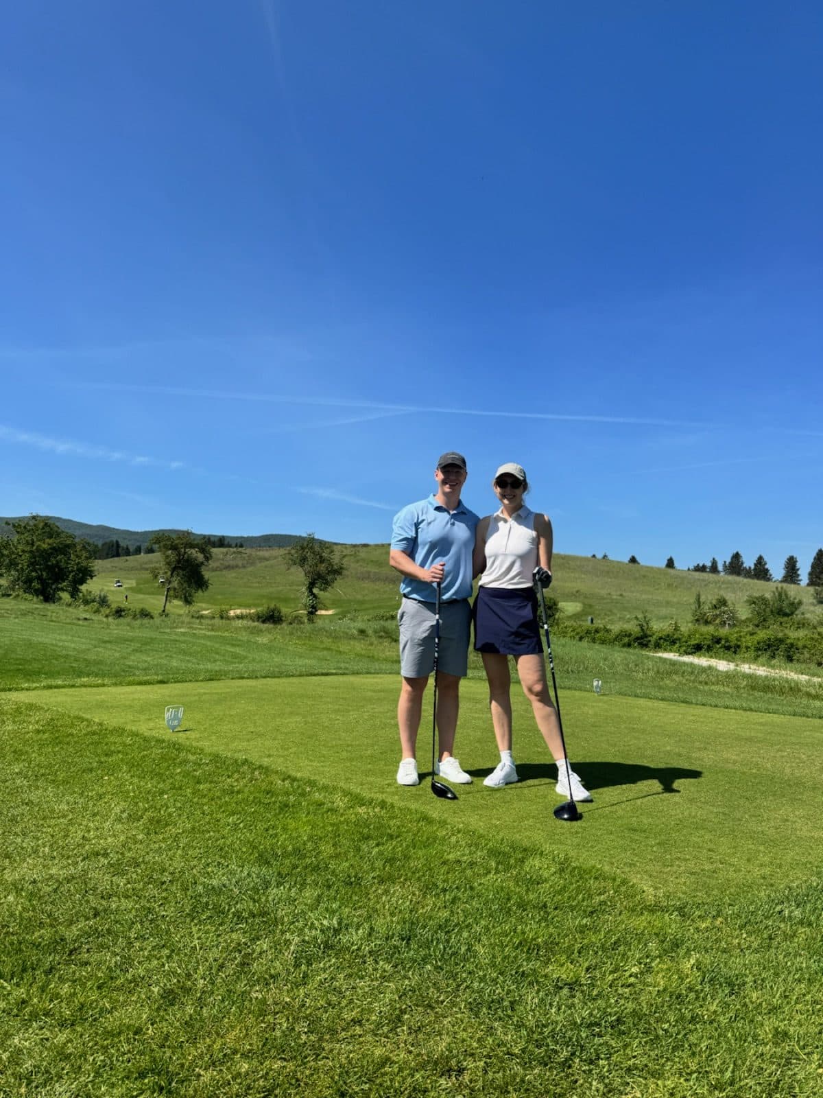Annie and a companion standing on a golf course