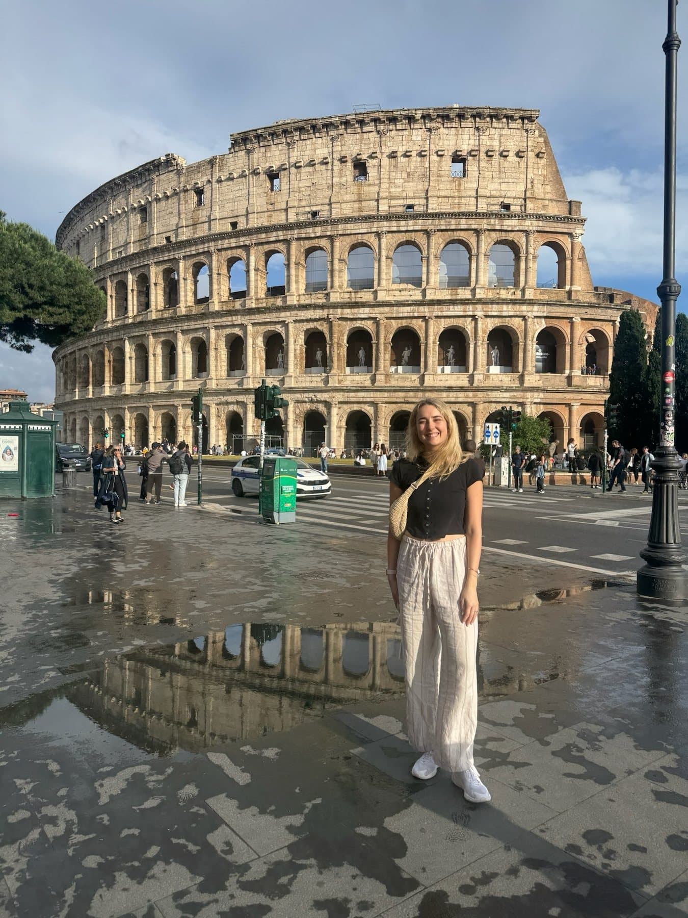 Annie smiling in front of the Colosseum in Rome
